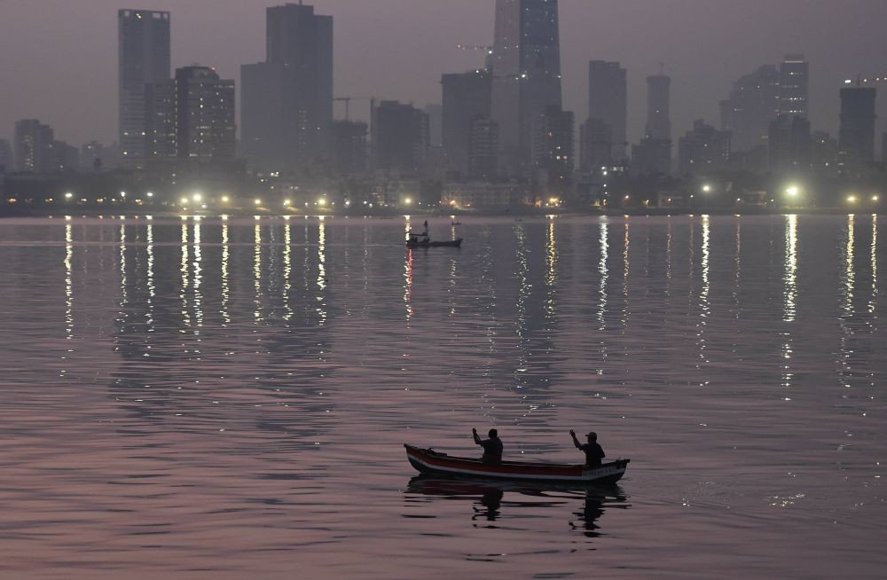 Mumbai: Fishermen row their boat in the Arabian Sea, during early morning hours, in Mumbai, Saturday, Feb. 6, 2021. (PTI Photo/Kunal Patil)